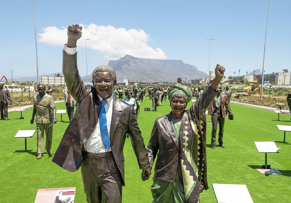 Century City Attractions 1 Statues of Nelson Mandela and Winnie Madikizela-Mandela raising fists, with Table Mountain behind.