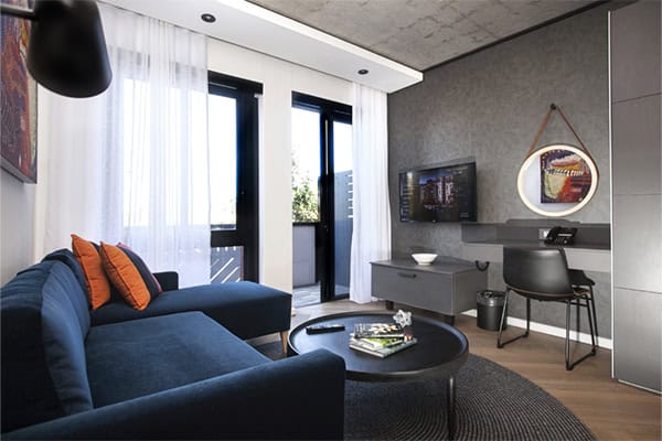 Bridgewater Hotel 53 A stylish modern apartment featuring a couch, coffee table, and television, ideal for relaxation in Century City Hotels.