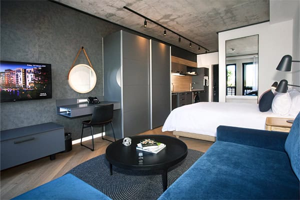 Bridgewater Hotel 52 A cozy bedroom featuring a bed, desk, and TV, ideal for relaxation at Century City Hotels.