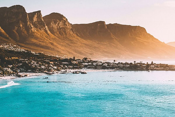 cape-town-beach Shot of one of Cape Town’s natural attractions: the beautiful coastline surrounded by mountains