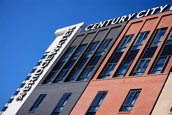 century-city-side-angle A building featuring a prominent sign displaying "Century City Hotel," showing one of the best hotels in Cape Town.