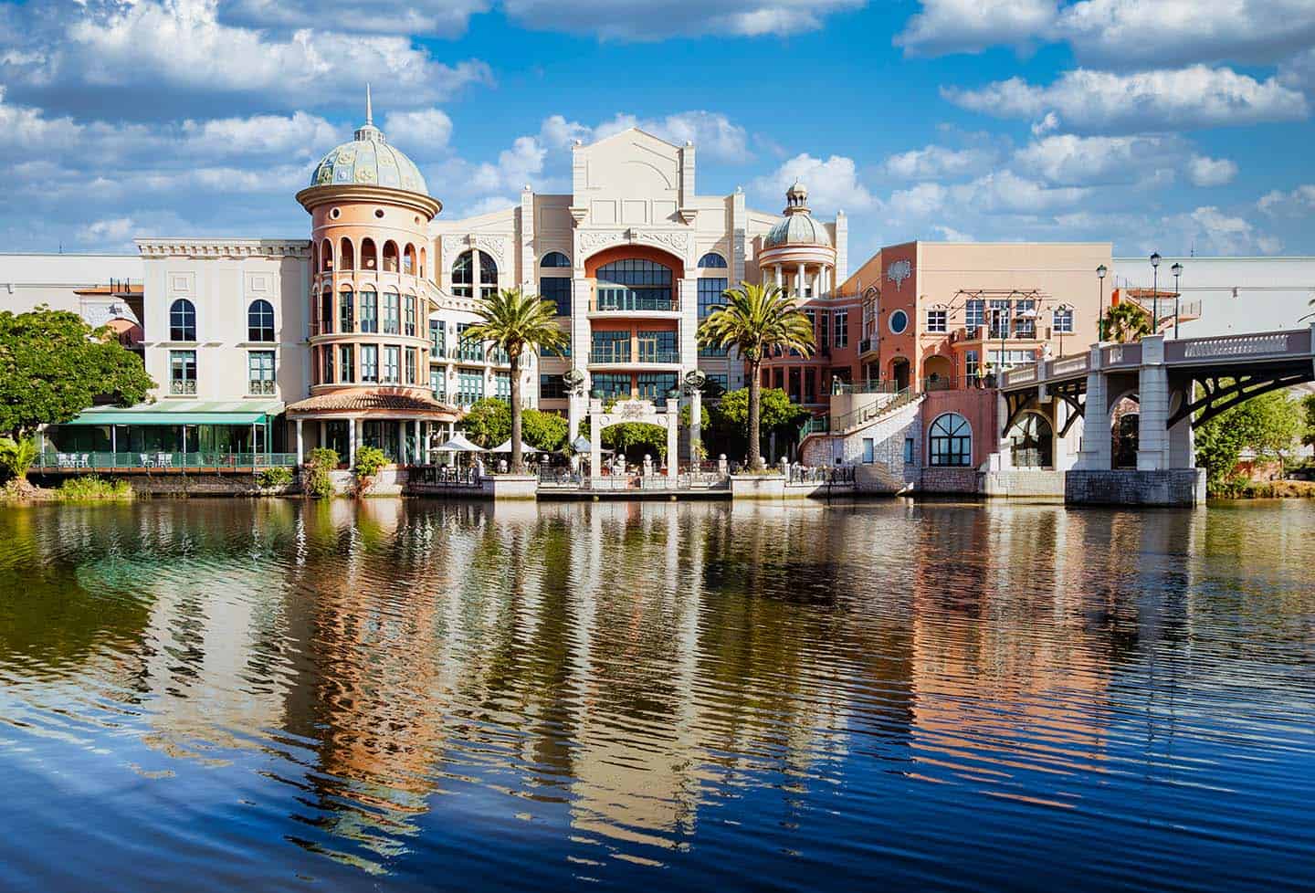 Century City Attractions 3 A stunning view of Century City Hotels with grand architecture, domed towers, palm trees, and a serene canal reflecting the scene.