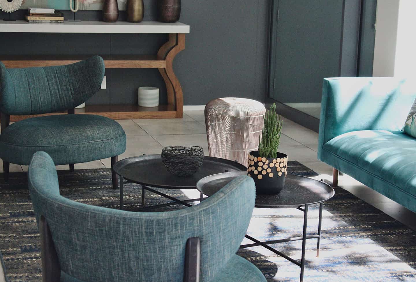 Home 3 Modern interior design featuring a light blue upholstered armchair and a matching sofa, positioned around a small, round metal-framed table.