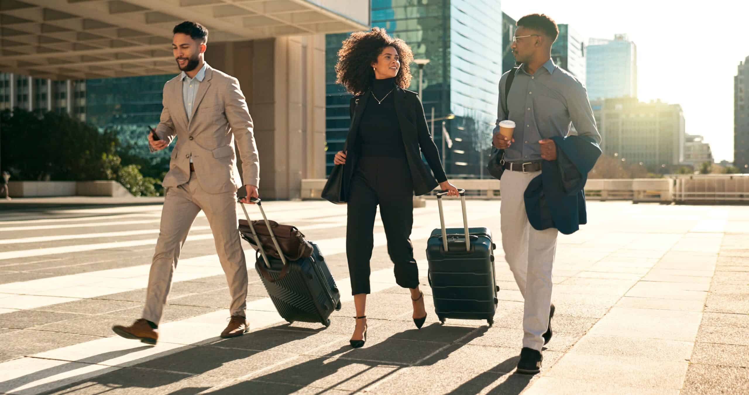 business team walking with suitcases (1) 3 professionals walking in a commercial district on their way to one of the business hotels in Cape Town