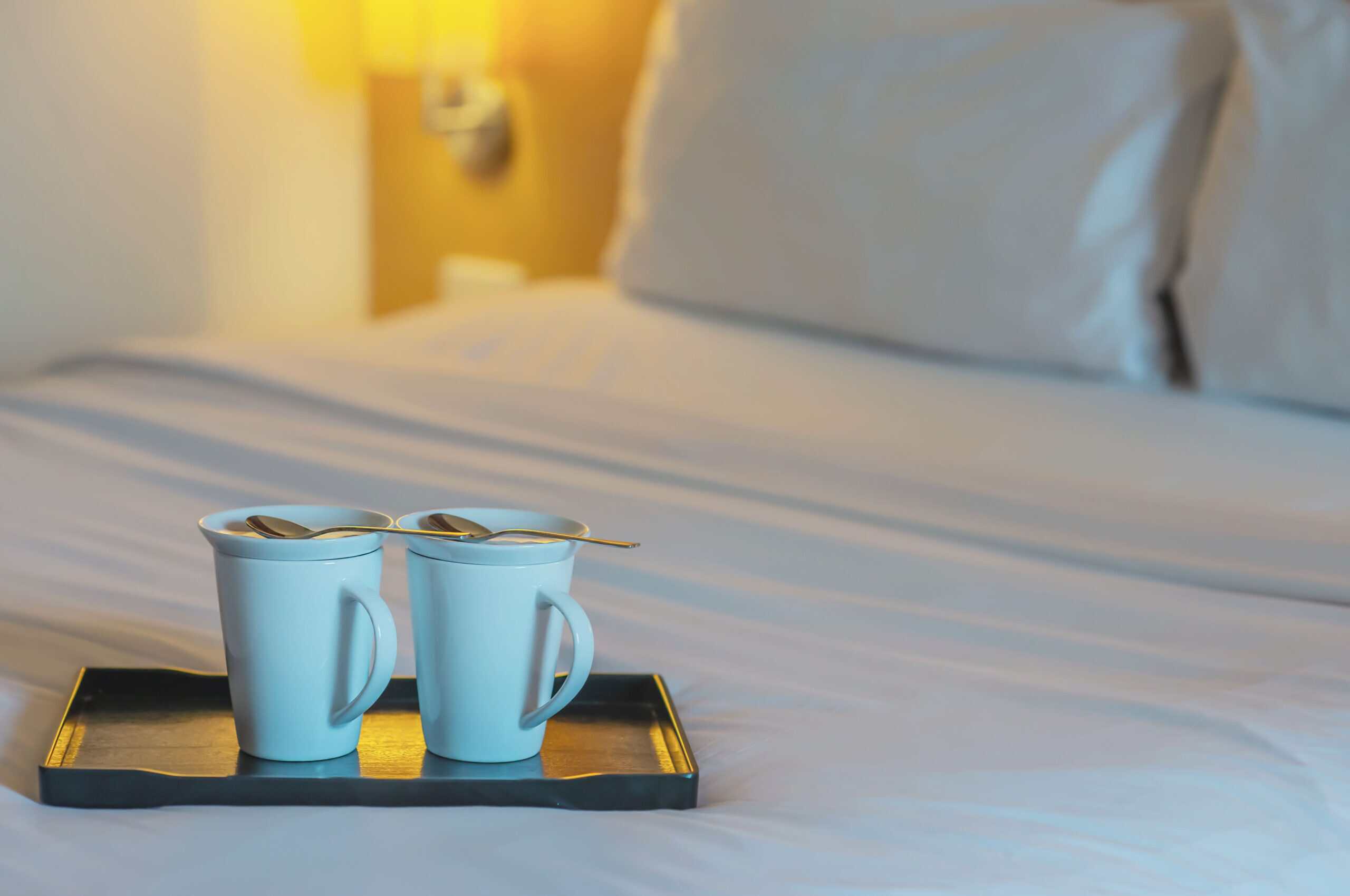 hotel-room-hotel-vacation (1) A cosy hotel room with twin coffee cups on a bed showing a Cape Town staycation with Century City Hotels.
